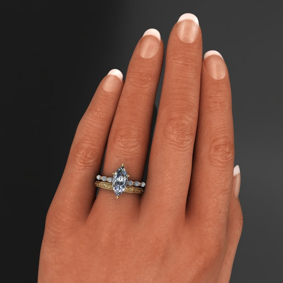 2 carat marquise engagement ring with marquise side stones and a vintage inspired wedding band - model hand with wedding band