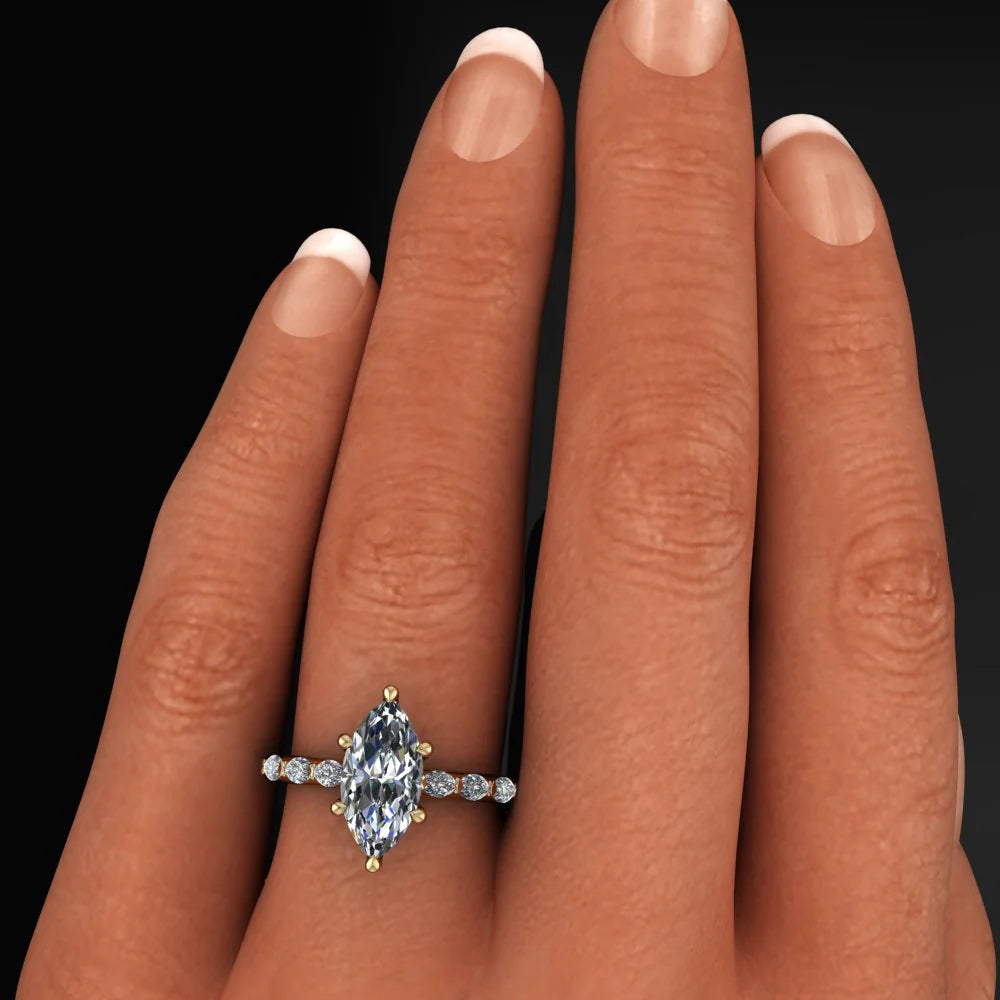 2 carat marquise engagement ring with marquise side stones and a vintage inspired wedding band - model hand