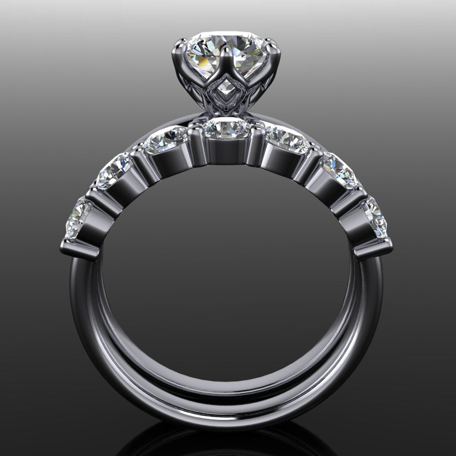 Six prong Phoenix engagement ring set with a round moissanite, paired with a 7 stone Bette anniversary band - through finger view