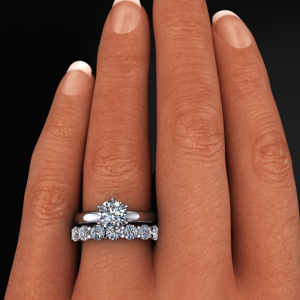 Six prong Phoenix engagement ring set with a round moissanite, paired with a 7 stone Bette anniversary band - model shot