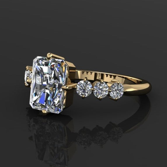 2 carat radiant moissanite center with six nicely sized side stone with prongs set north, south, east, and west.