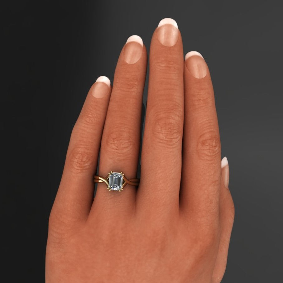 2 carat emerald solitaire ring with a 3.5mm wide band and double claw prongs - hand model view