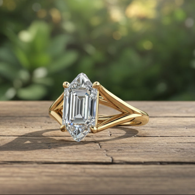 Gold ring with a large diamond on a rustic wooden table, with lush greenery in the background