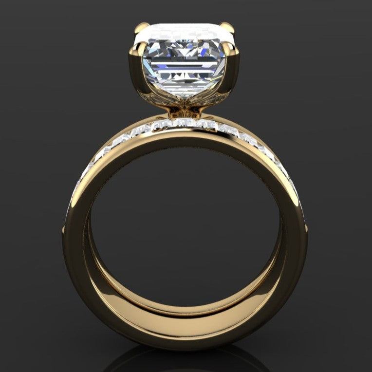 Gold ring with a 5 carat moissanite emerald solitaire center with a channel set baguette moissanite band - profile view 