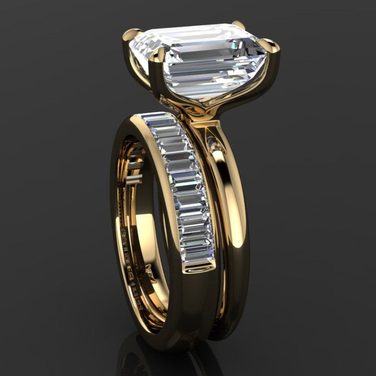 Gold ring with a 5 carat moissanite emerald solitaire center with a channel set baguette moissanite band - side view 