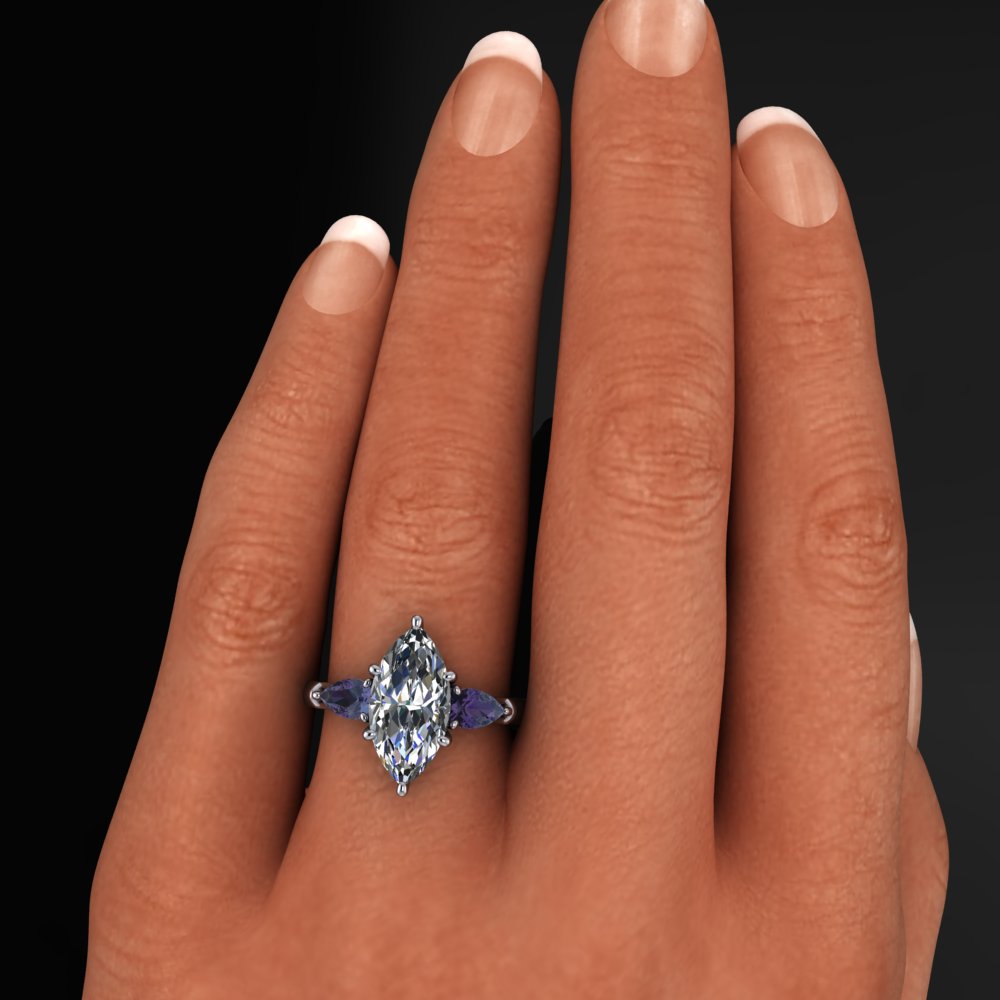 2 carat marquise moissanite three stone ring with lab created alexandrite side stones on a hand model