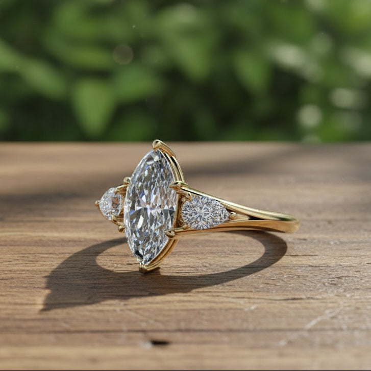 Gold ring with a large diamond on a wooden surface with a blurred green background