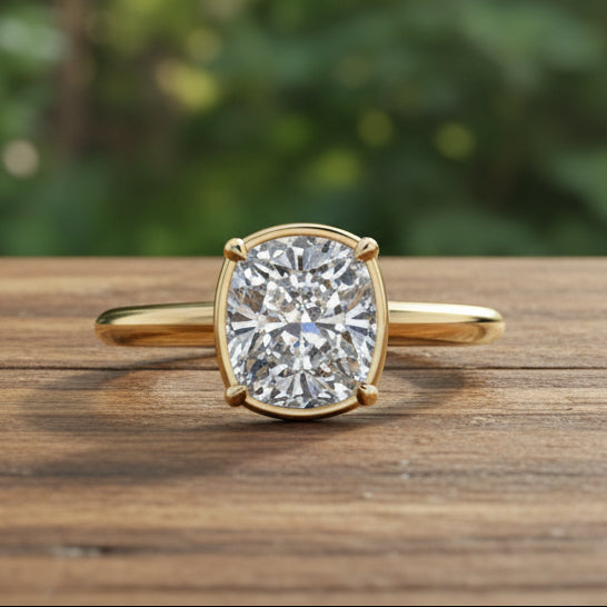 Gold ring with a large diamond on a reflective surface