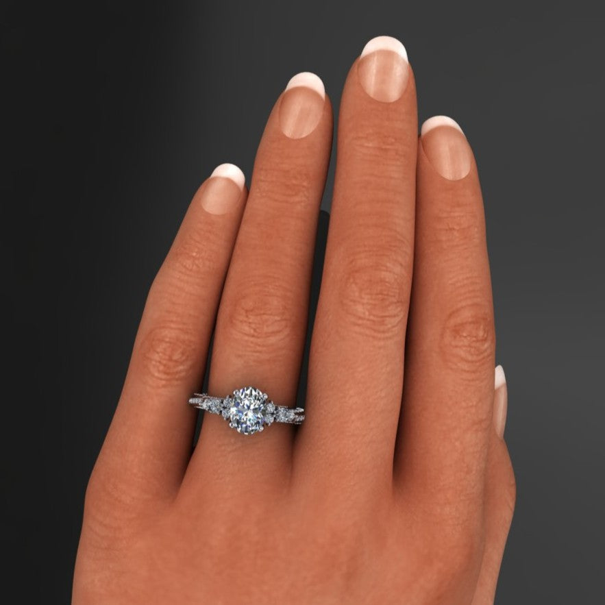 1.8 carat oval moissanite ring with lab grown diamond accent stones on a wooden surface - hand model view