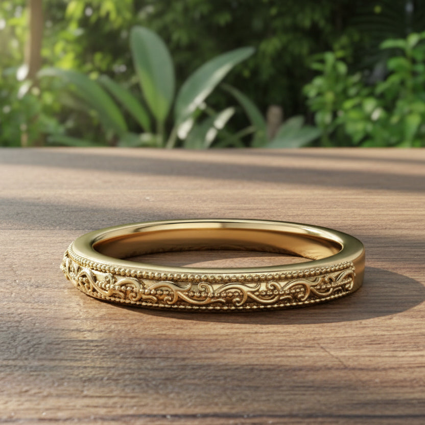 Gold ring with intricate designs on a wooden surface