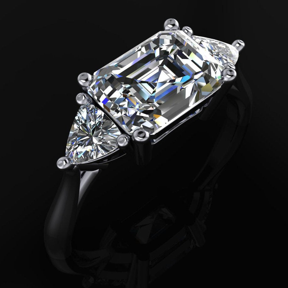 Emerald cut 3 stone moissanite engagement ring - angle view