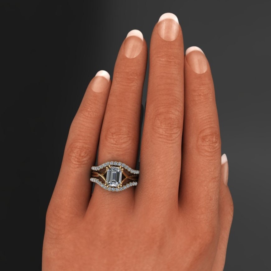 1.75 carat emerald cut lab grown diamond. G color, VS1 clarity, solitaire engagement ring with a split band and double claw prongs -hand model view