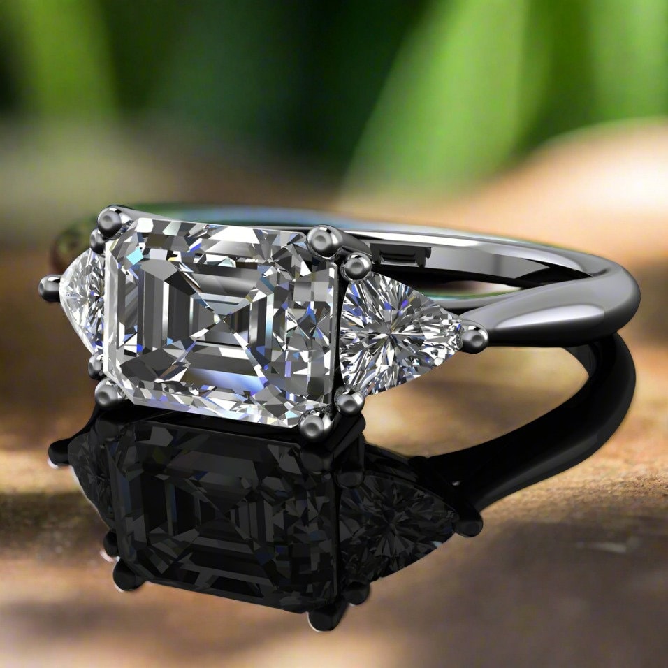 erin ring - emerald cut lab grown diamond engagement ring - flat on a table