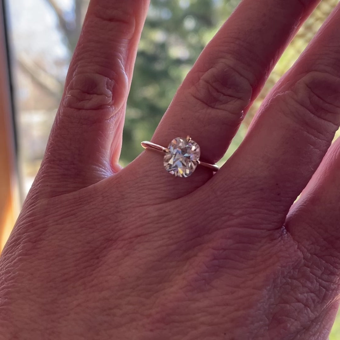 2 carat elongated cushion solitaire ring set with north, south, east, west prongs - hand model view