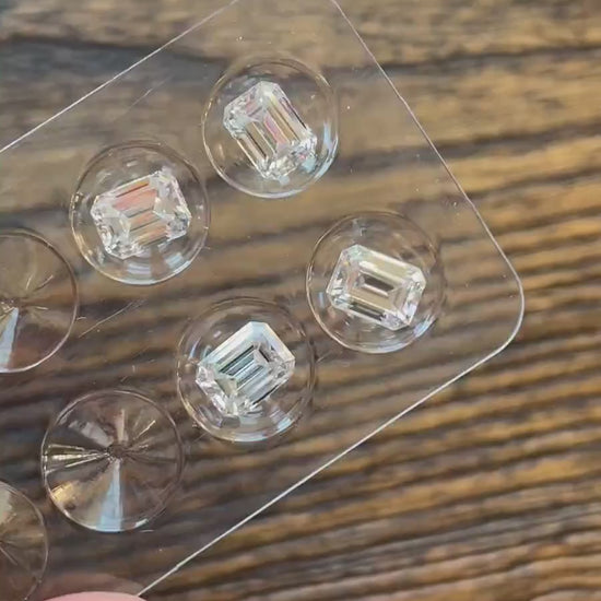 video of 4 loose emerald cut moissanite stones