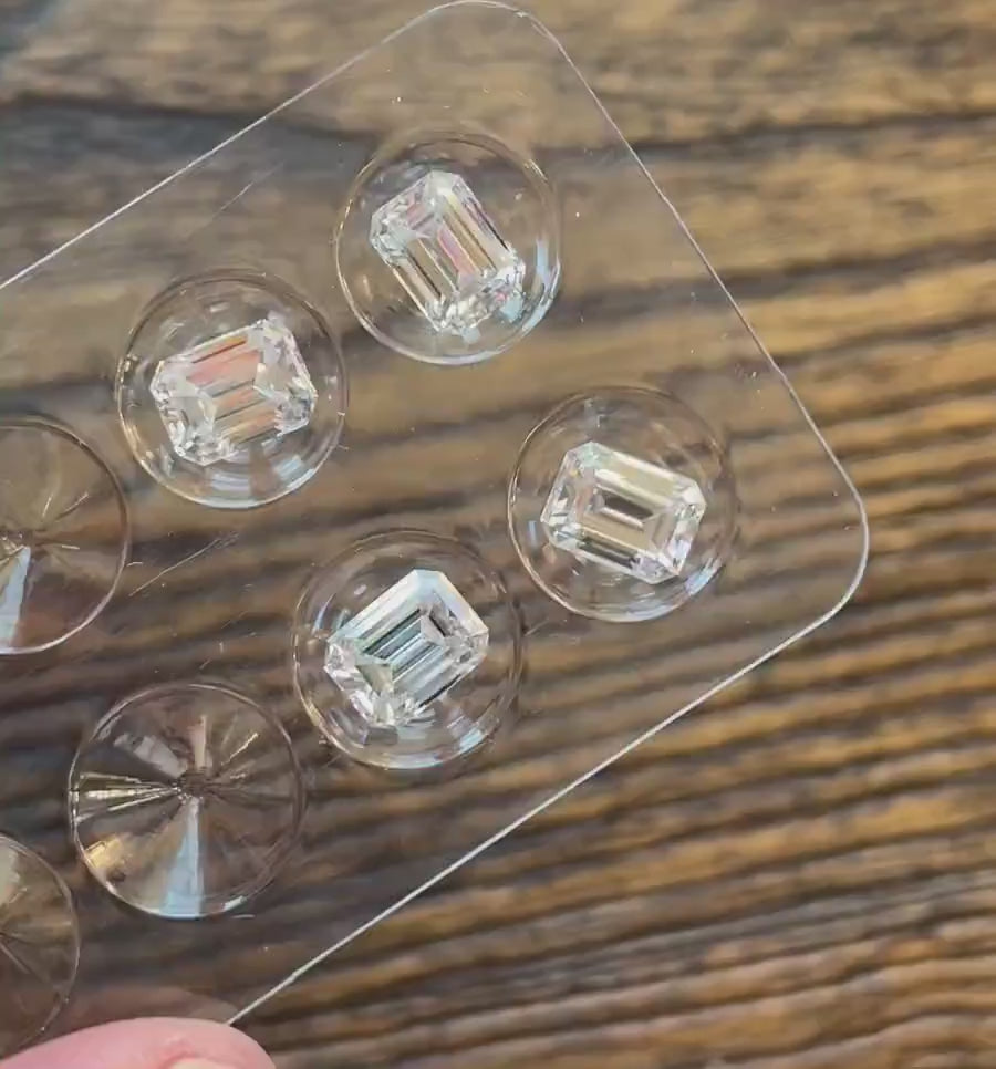 video of 4 loose emerald cut moissanite stones