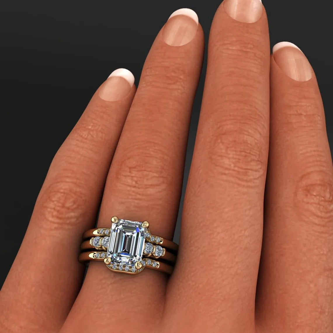 dallas ring – 2.5 carat emerald cut NEO moissanite engagement ring with matching bands on hand model - J Hollywood Designs