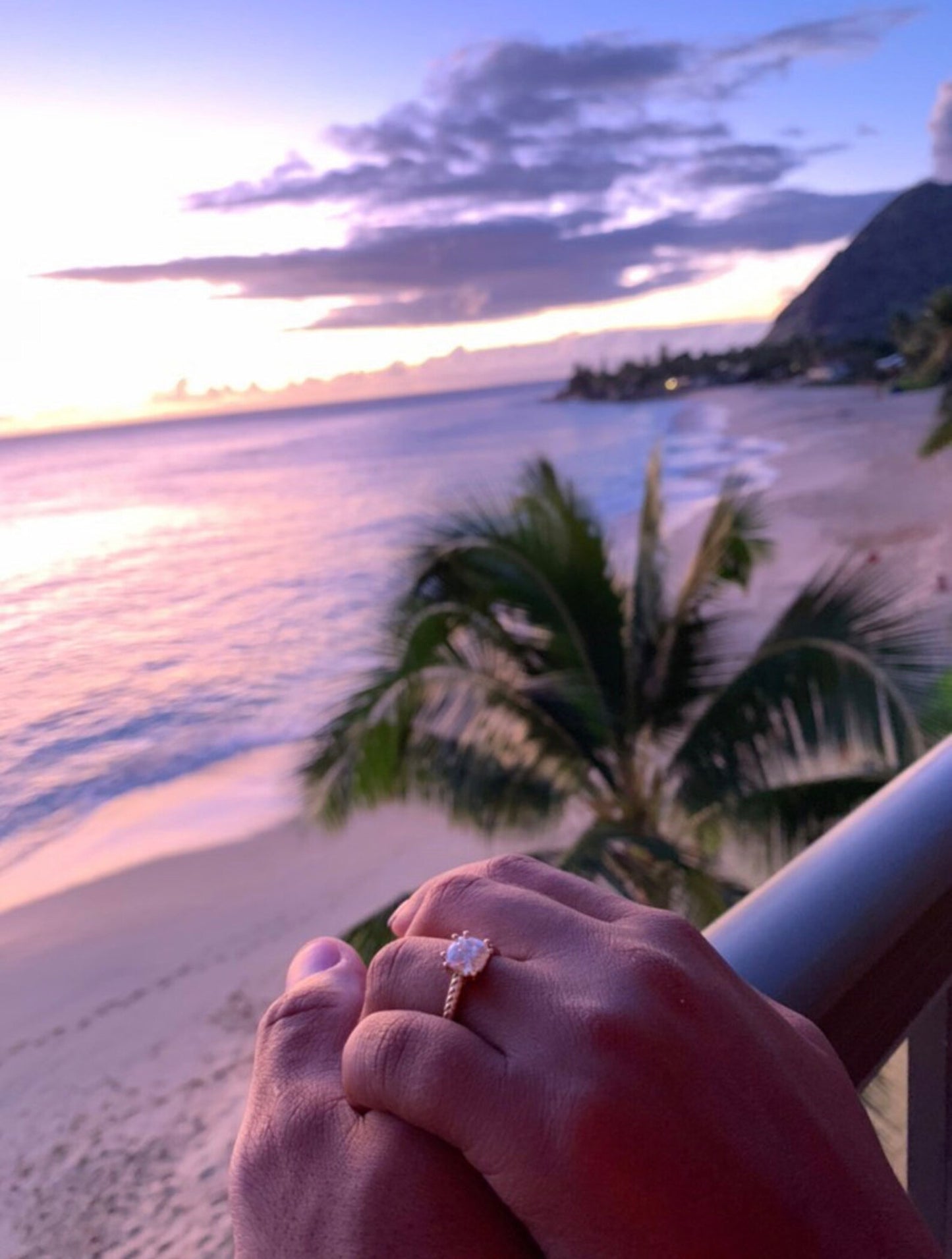 one of our rings in the wild - engagement photo with a gorgeous tropical beach background- J Hollywood Designs